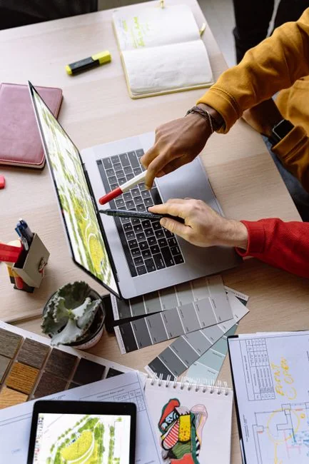 A miniature shopping cart placed on a laptop keyboard symbolizing online shopping and e-commerce.